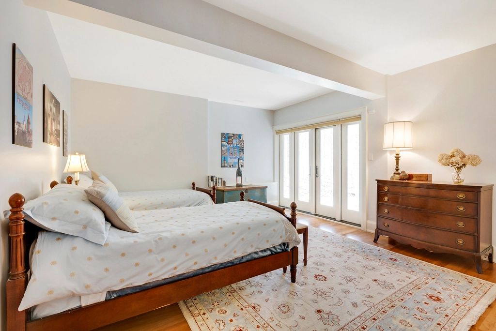 A guest room with two beds and a window